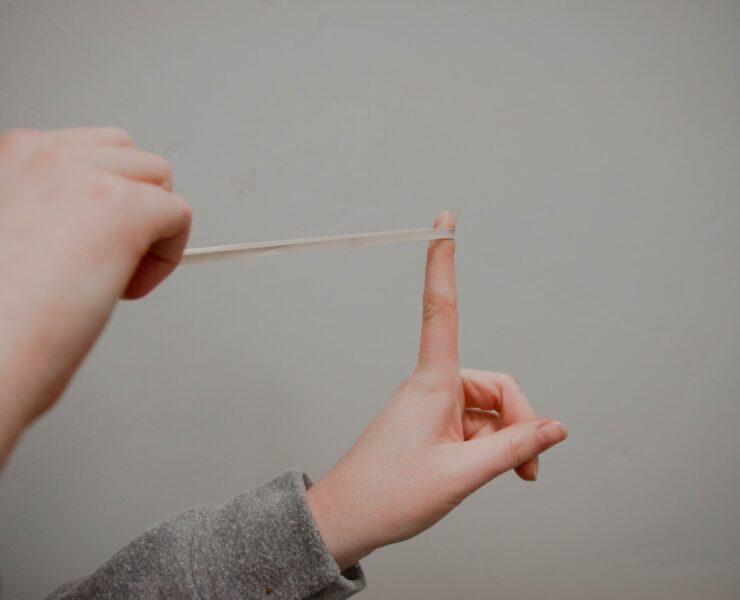 person holding rubberband
